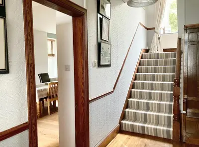 a staircase in a home with a stair case at Laurel Bank House in Penrith