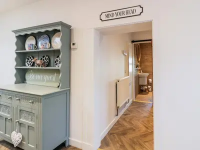 a hallway with a blue cabinet in a house at Smithy House in Dumfries