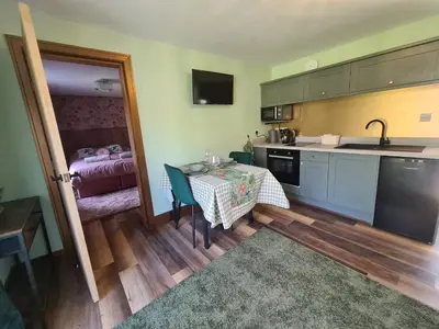 a small kitchen with a table and a room at The Nest by Blake view holidays, a peaceful boutique retreat, 3 miles from Ennerdale- small twin or king bed available in Rowrah