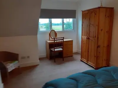 a bedroom with a desk and a chair and a table at Odea Hot tub Holiday Cottage in Dumfries