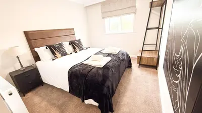 a bedroom with a large bed with two towels on it at Wheyrigg Hall Hotel in Wheyrigg