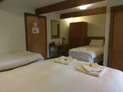 a hotel room with two beds with towels on them at Wheyrigg Hall Hotel in Wheyrigg