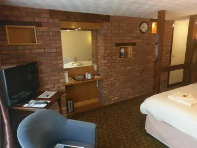 a hotel room with a bed and a television at Wheyrigg Hall Hotel in Wheyrigg