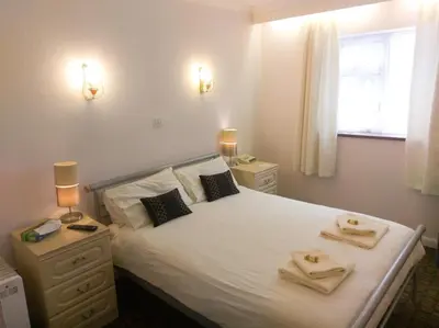 a bedroom with a bed with two towels on it at Wheyrigg Hall Hotel in Wheyrigg