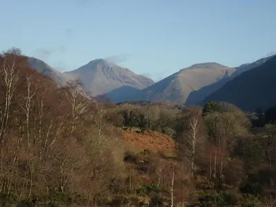 a mountain range with trees and mountains in the background at The Barn in Seascale