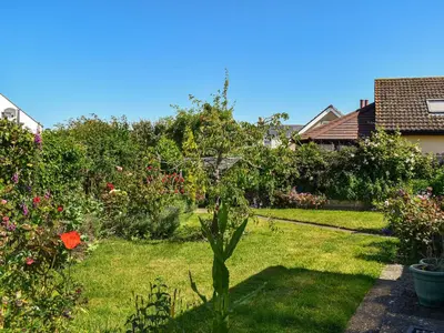 a garden with a tree in the grass at Teazles in Peel