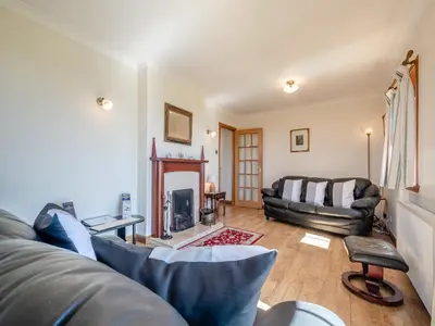 a living room with a couch and a fireplace at Barnstable - Uk46888 in Kilmory