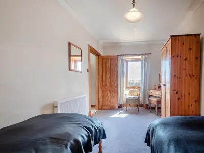 a bedroom with a bed and a desk in it at Kilbride Cottage-Uk46886 in Kilmory