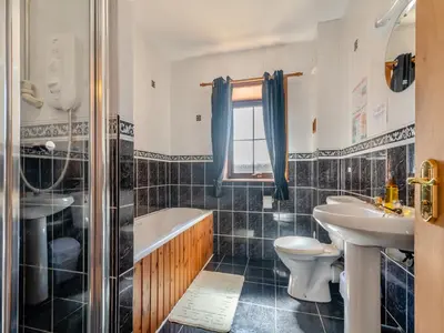 a bathroom with a sink and a tub and a toilet at Eryb Cottage - Uk46883 in Kilmory