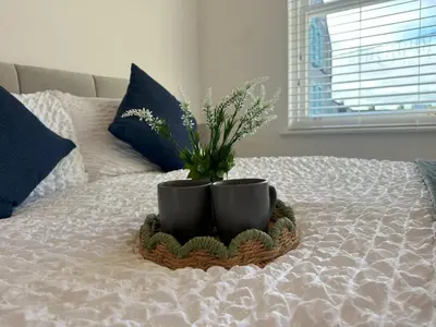 a tray with two pots with plants on a bed at Curwen Apartment - 2 Bedrooms - Sleeps 6 in Workington