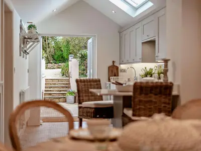 a kitchen with a table and chairs and an open door at 2 Bed in Cockermouth 94787 in Broughton Moor