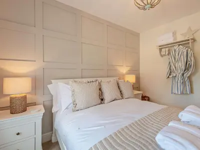 a bedroom with a large white bed with two lamps at 2 Bed in Cockermouth 94787 in Broughton Moor