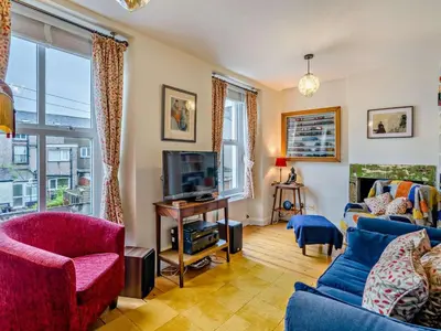 a living room with a blue couch and a tv at 3 Bed in Cockermouth oc-94928 in Cockermouth