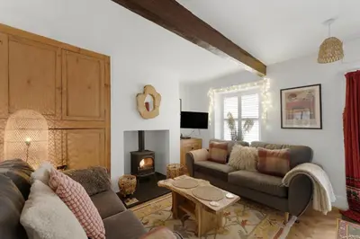 a living room with a couch and a fireplace at Darwin Cottage in Keswick