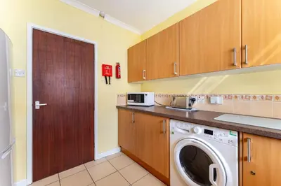 a laundry room with a washer and dryer in it at Lakeland Nook in Keswick