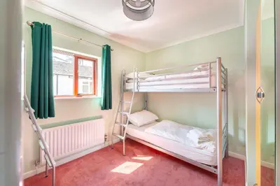 a room with two bunk beds and a window at Lakeland Nook in Keswick