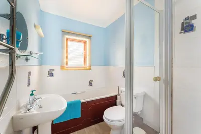 a bathroom with a toilet and a sink and a tub at Lakeland Nook in Keswick