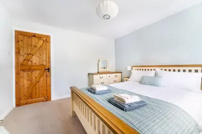 a bedroom with a bed with two towels on it at The Mews in Keswick