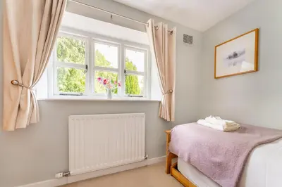 a bedroom with a bed and a window at The Mews in Keswick