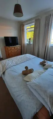 a bedroom with two teddy bears on a bed at The White Heather Hotel in Wigton