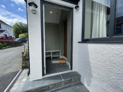a window of a building with a bench in it at Glenn Cottage in Braithwaite