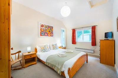 a bedroom with a bed and a tv in it at Carr Crag Pavilion in Little Langdale