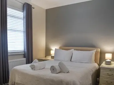 a bedroom with a bed with two towels on it at Courtyard View in Keswick