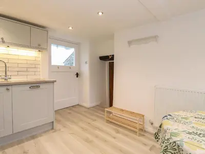a kitchen and a bedroom with a bed and a sink at Two Side House Farm in Ambleside