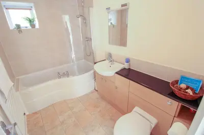 a bathroom with a toilet and a sink and a shower at Bramble Cottage perfect for a relaxing romantic break in Keswick in Keswick