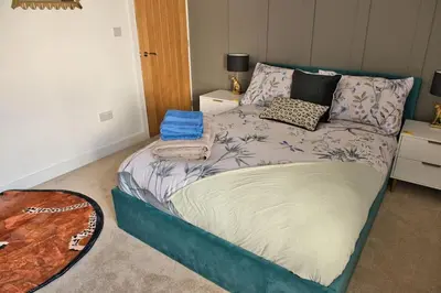 a bedroom with a bed with pillows on it at Quirky & Comfortable Residence in Workington