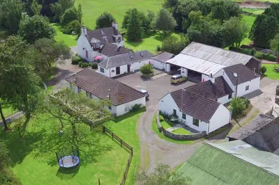 an aerial view of a large house with a yard at Courtyard Cottages, Garden Cottage in Wigtown
