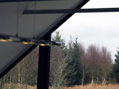 a view of a forest of trees from a window at Cot Cottage - Panoramic Views & Hot Tub! in Castle Douglas