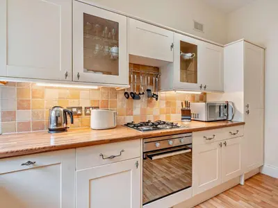 a kitchen with white cabinets and a stove top oven at 2 Bed in Keswick oc-94995 in Keswick