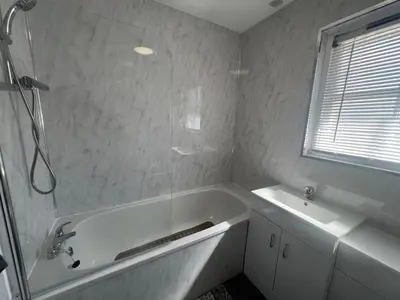 a white bathroom with a tub and a sink at No 6, Ayr, 140m2, New Decor 2024, 3bedroom, detached house, with private gardens in Ayr