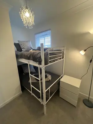 a dorm room with a bunk bed and a lamp at No 6, Ayr, 140m2, New Decor 2024, 3bedroom, detached house, with private gardens in Ayr