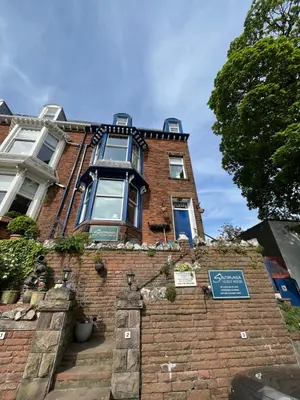 a large brick building with a sign on it at Shemara rooms in Keswick
