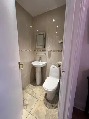 a bathroom with a toilet and a sink at Shemara rooms in Keswick