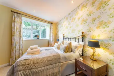 a bedroom with a bed and a window at Grey Crag Barn in Grasmere