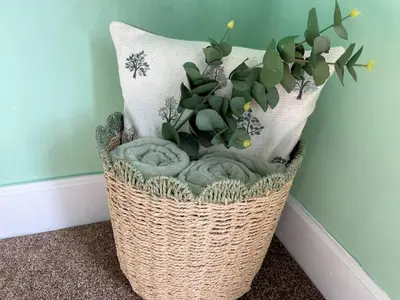 a wicker basket with a plant in the corner of a room at Beautiful House With Stunning Views Kirkcudbright - Pass the Keys in Kirkcudbright