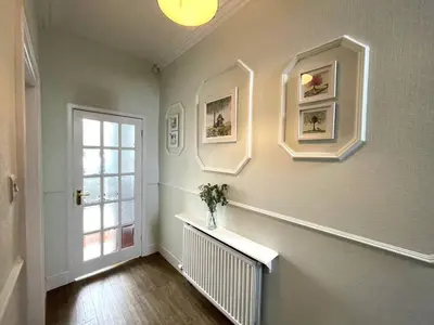 a hallway with a vase on a shelf and a window at Beautiful House With Stunning Views Kirkcudbright - Pass the Keys in Kirkcudbright