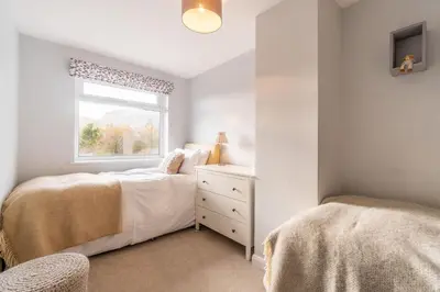 a bedroom with two beds and a window at Number One in Chapel Stile