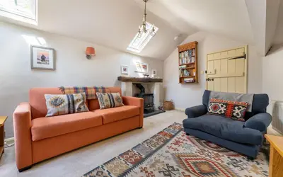 a living room with a couch and a chair at Poet's Corner in Grasmere