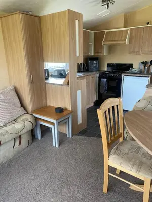 a small kitchen with a couch and a table at 23 The Beeches in Gilcrux