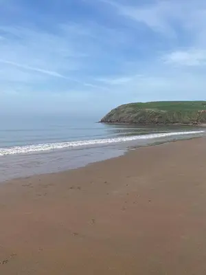 a sandy beach with the ocean in the background at 23 The Beeches in Gilcrux
