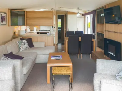 a living room with a couch and a table at Stream Side View in Lamplugh