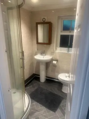 a bathroom with a sink and a toilet at The hot tub by the waterfall - facilities included in Lower Foxdale