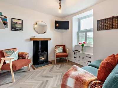 a living room with a couch and a fireplace at 2 Bed in Arlecdon 95126 in Arlecdon