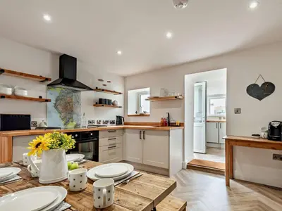 a kitchen with a table with plates on it at 2 Bed in Arlecdon 95126 in Arlecdon