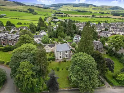 an aerial view of a village with houses and trees at Above & Beyond at Warriston Lodge in Moffat
