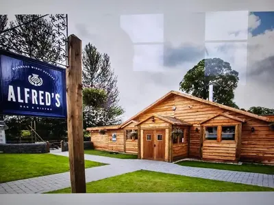 a sign in front of a log cabin at Luxury static caravan in Beattock